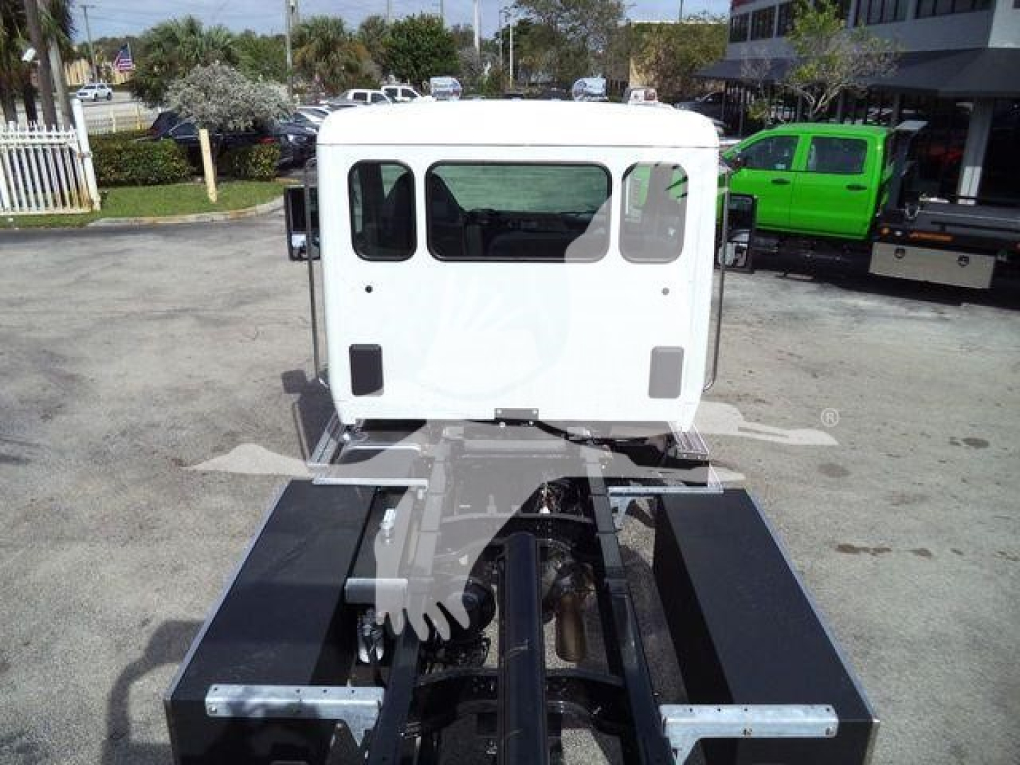 Truck cab of a Kenworth T280 with rollback chassis showing rear view and hydraulic components.