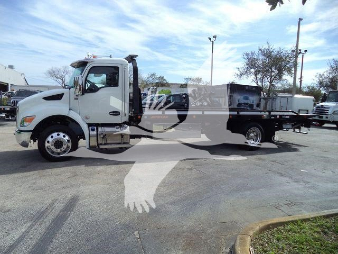 Kenworth T280 rollback wrecker truck side view showing cab and flatbed with chrome wheels and equipment.