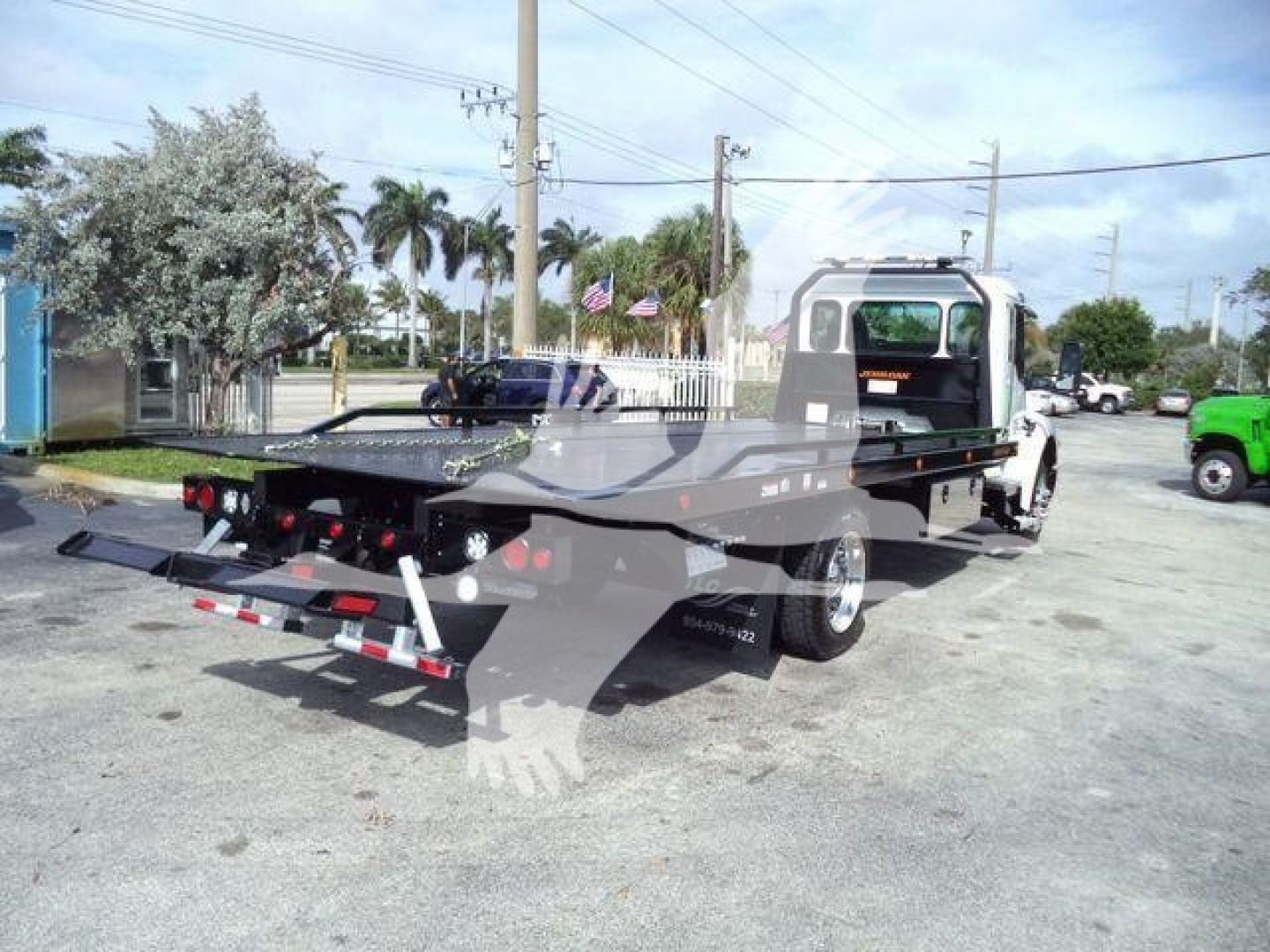 Kenworth T280 rollback truck in yard showing rear incline bed and hydraulic winch; stock WKWT280XLP22; new unit.