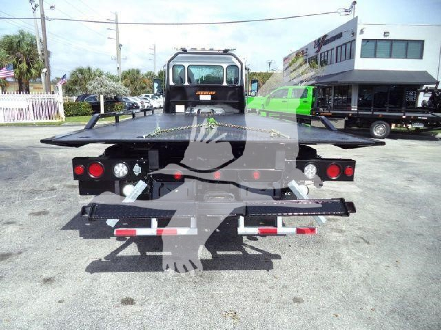 Kenworth T280 rollback truck rear view showing loading platform and taillights.