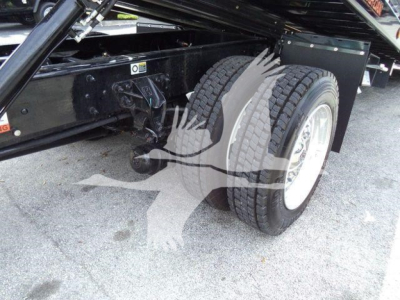 Kenworth truck chassis with dual rear wheels and suspension, side view showing undercarriage and frame attachment points.