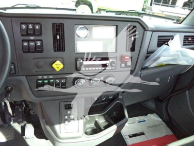 Cat  Kenworth T280 dashboard with various controls and gauges; center console and gear selector visible.