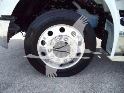 Truck front wheel and fender showing steel wheel with lug nuts and tire, part of a Kenworth T280 semi-truck cab in a rollback configuration.