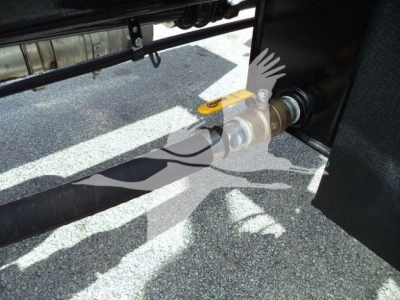 Kenworth T280 rollback truck hitch area with valve handle and hydraulic connection. Visible components include a yellow-handled valve and a metallic coupling near a black panel.