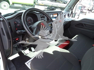 Truck interior showing steering wheel, instrument cluster, and front seats of a new Kenworth T280 rollback truck.