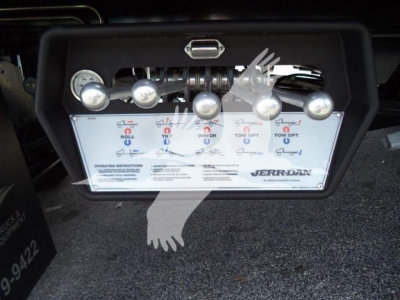 Kenworth rollback control panel showing levers labeled Roll, Tilt, Wing, and Tow options with brand JERR-DAN; includes operating instructions and gauges.
