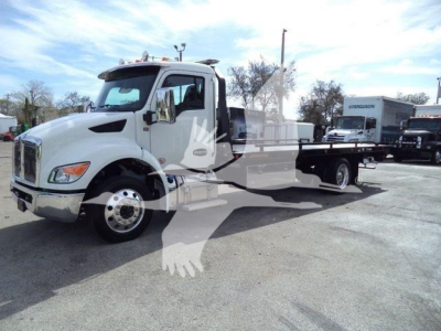 Kenworth T280 rollback truck from left front view showing cab and long wheelbase bed with chassis.