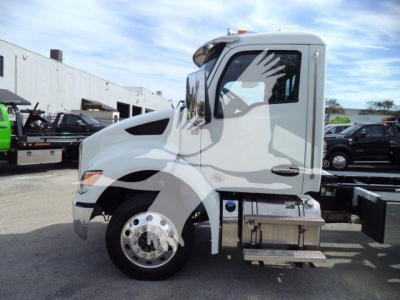 Kenworth T280 rollback truck in white profile view showing cab, front wheel, and metal steps with storage compartments.