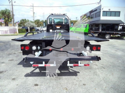 Kenworth T280 rollback truck rear view showing loading platform and taillights.
