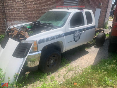 Chevrolet Silverado 2500HD 4x4 utility pickup in service with lifeguards decal, front hood open showing engine area and removed front bumper panels.
