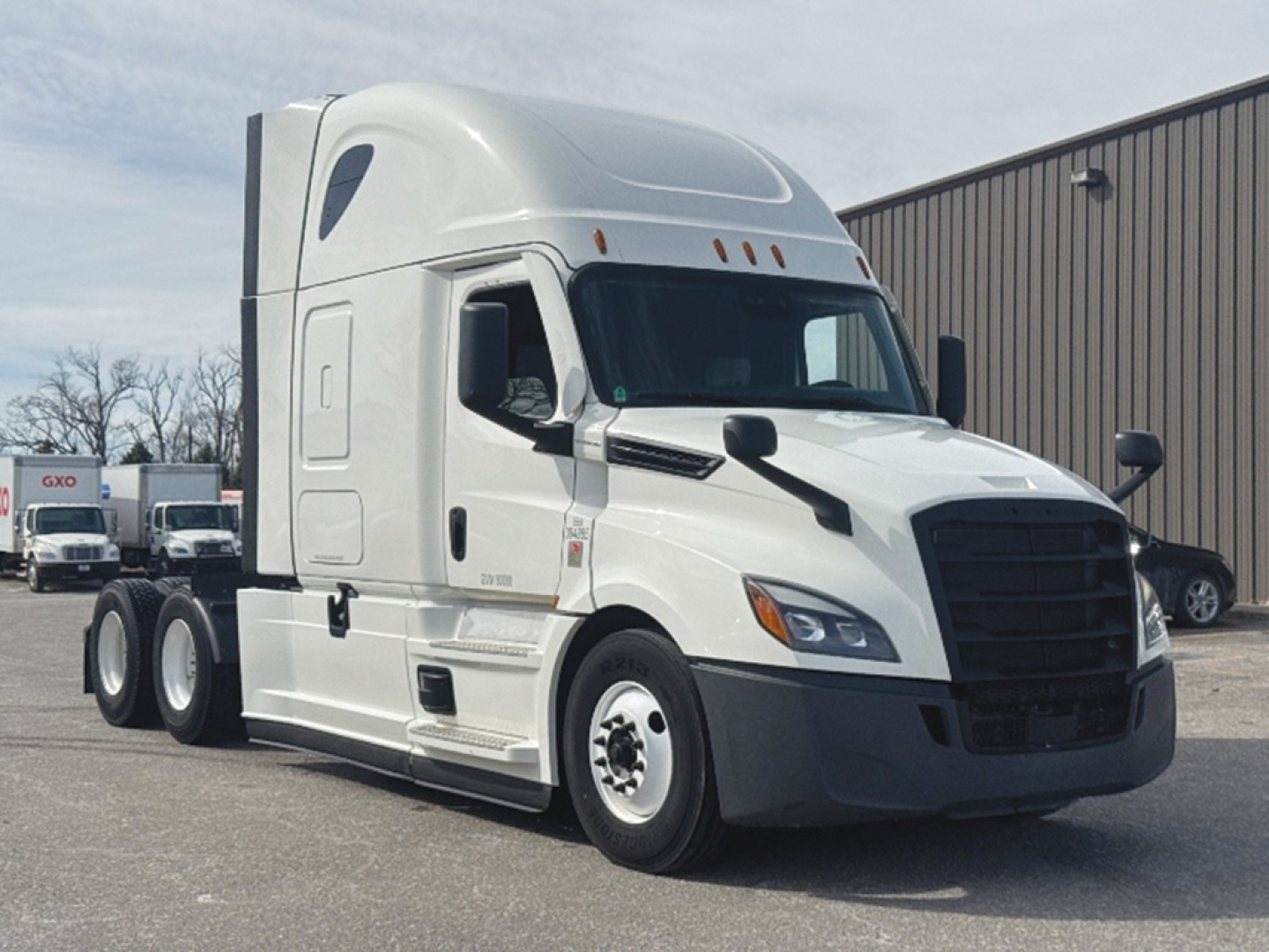 Freightliner Cascadia126 conventional sleeper tractor in white, front three-quarter view, with cab and sleeper aerodynamic fairing.