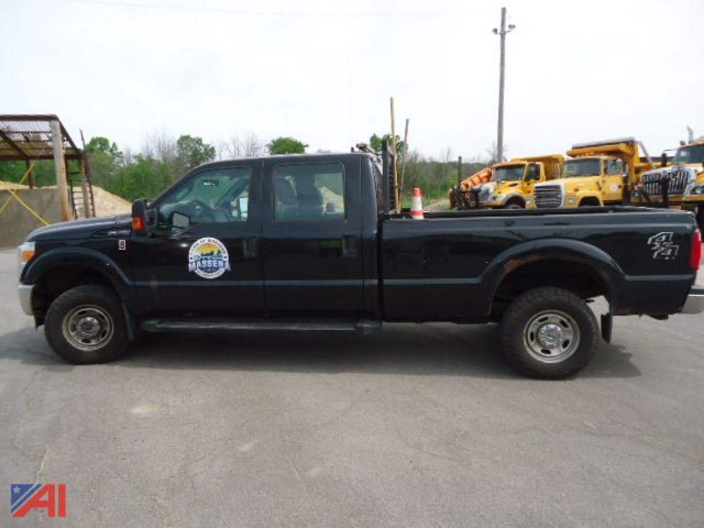 Ford F-350 Super Duty crew cab pickup truck side view with logo on door and black paint.
