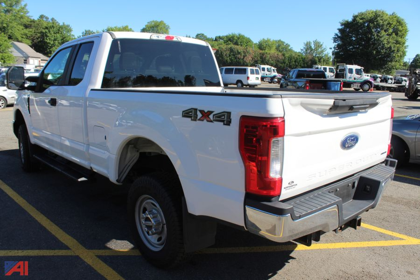 Ford F-250 Super Duty pickup truck 4x4 tailgate view showing rear badge and white body.