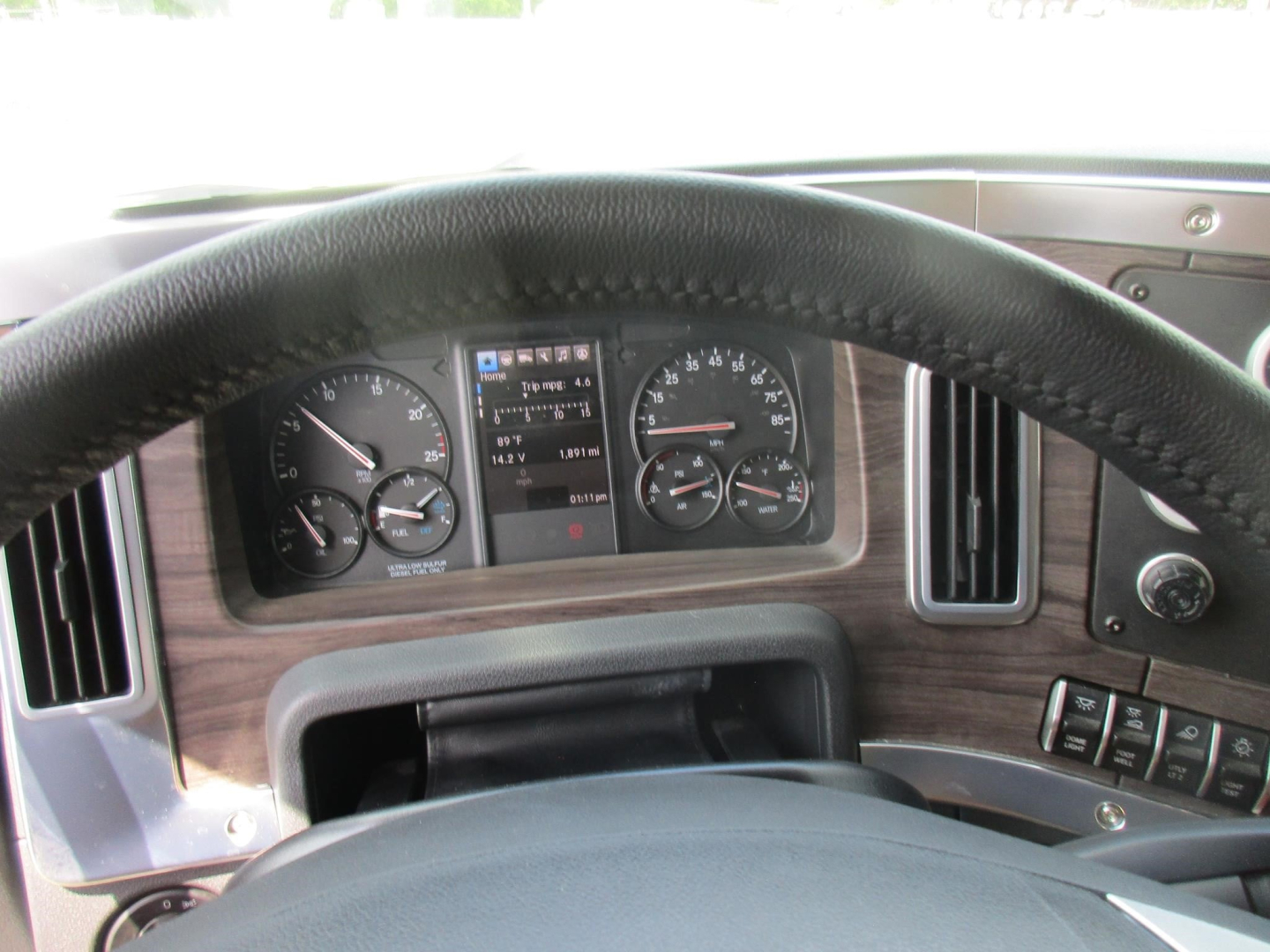 Western Star 49X truck interior cockpit with steering wheel and instrument cluster showing gauges and controls.