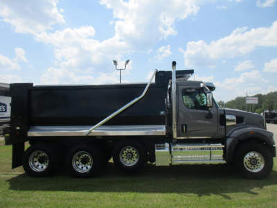 Western Star 49X dump truck side view showing black dump body, chrome step rails, and dual rear wheels.