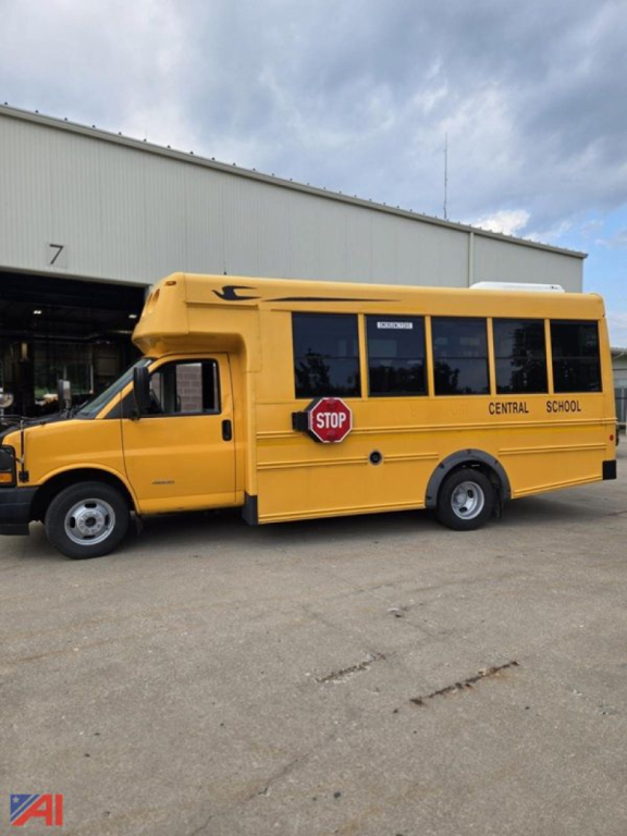 Side view of a yellow 2017 Chevrolet Express G4500 mini school bus with 'CENTRAL SCHOOL' lettering and a STOP sign emblem near the door.