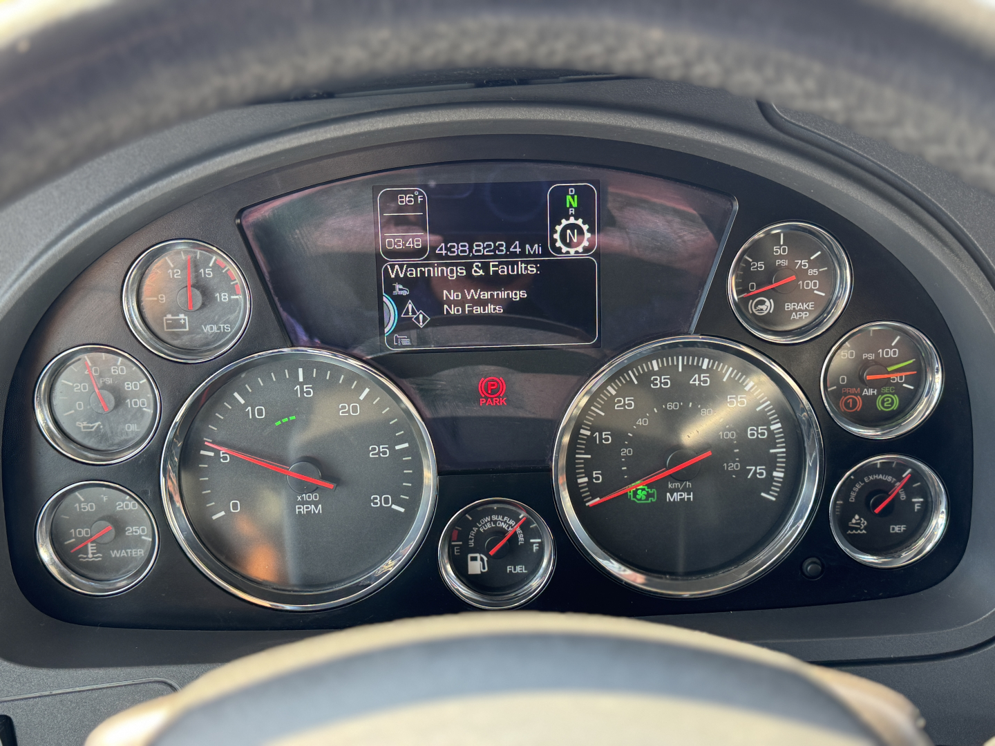 Kenworth truck dash cluster showing multiple gauges, center digital display with warnings: No Warnings, No Errors.