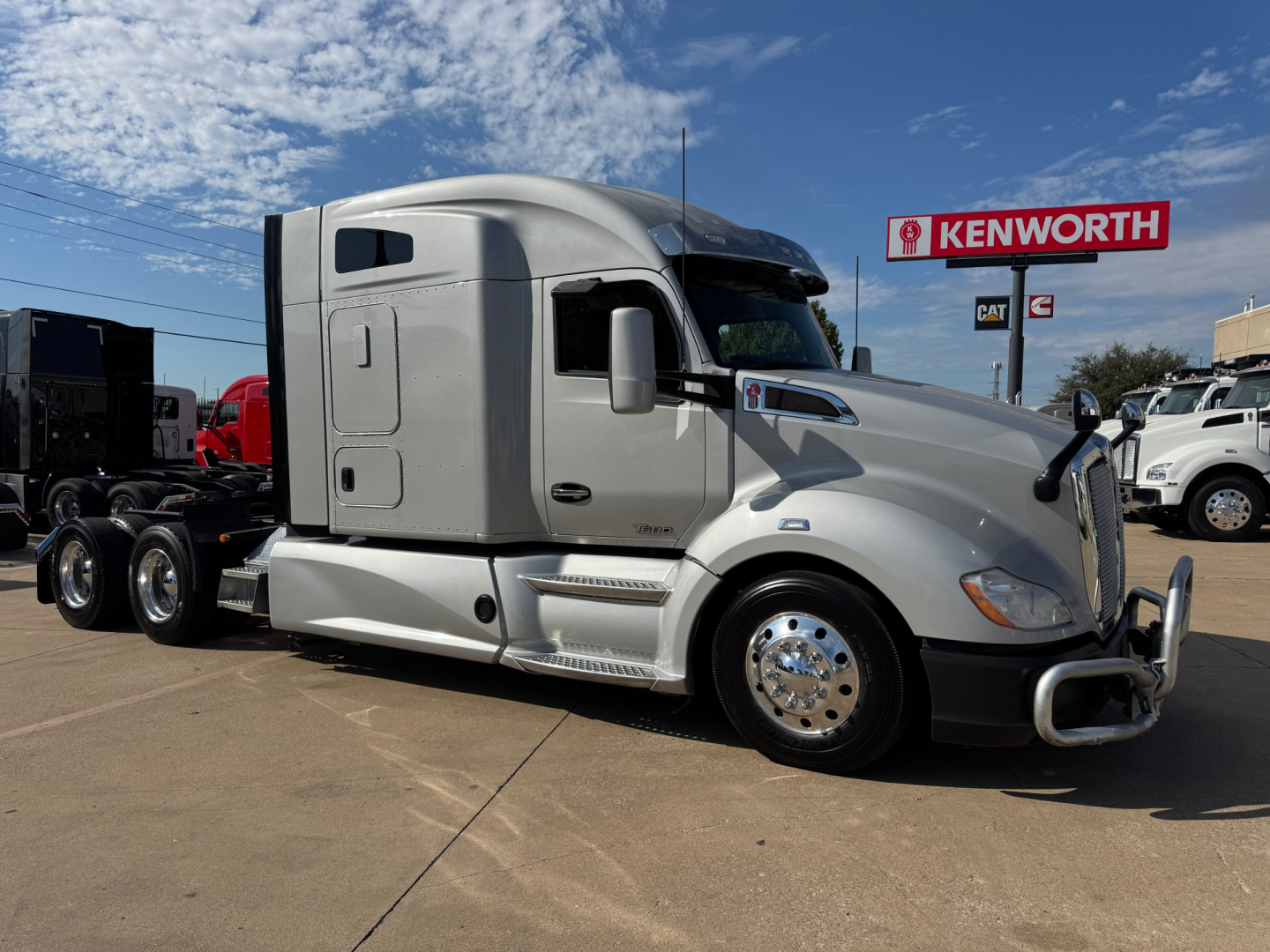 Kenworth T680 tractor in side view showing sleeper cab and chrome wheels