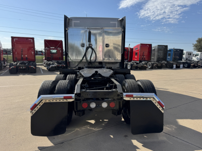 Kenworth T680 tractor rear view showing fifth wheel, dual rear axles, and mud flaps.