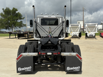 Mack PI64T cab chassis showing front view with dual rear axles and mud flaps labeled Bruckner's Truck & Equipment, stock number 73237.