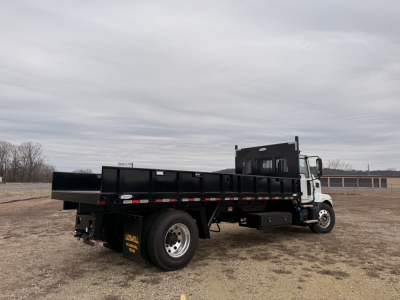 Flatbed truck showing cargo bed and Mack MD7 cab, VIN 1M2MDBAA3SS077490, stock 67965, new unit in a yard.