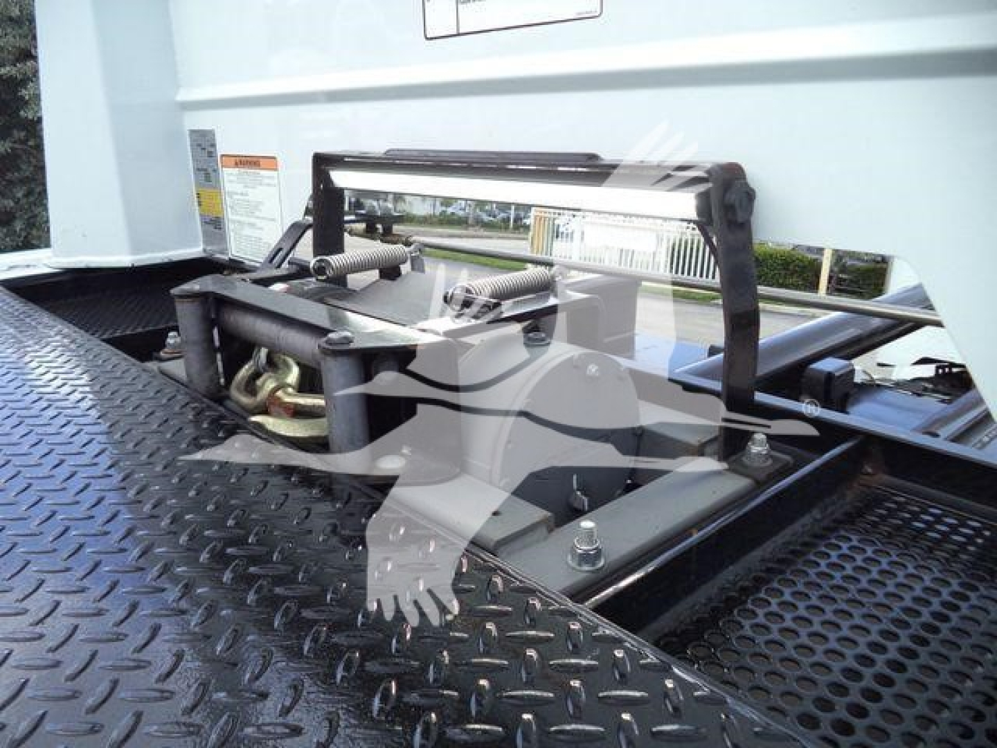 Trucks equipment bay of a 2022 Peterbilt 337 showing a platform with a portable maintenance step and metal diamond plate surface.