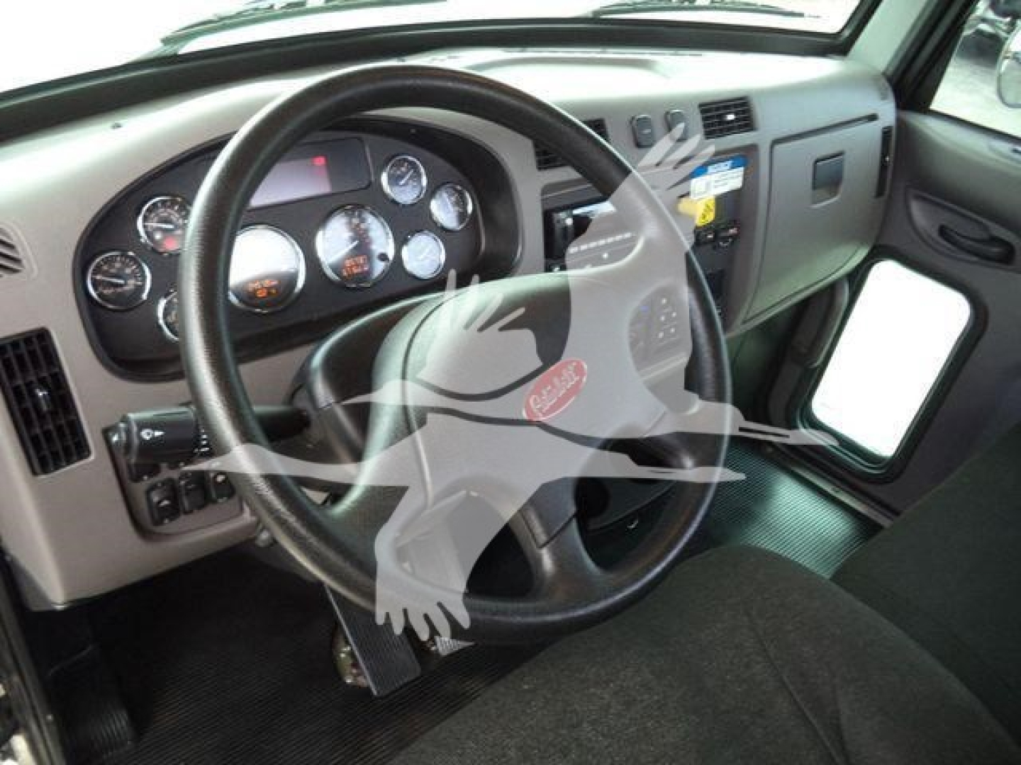 Peterbilt 337 cockpit view showing steering wheel and gauge cluster.