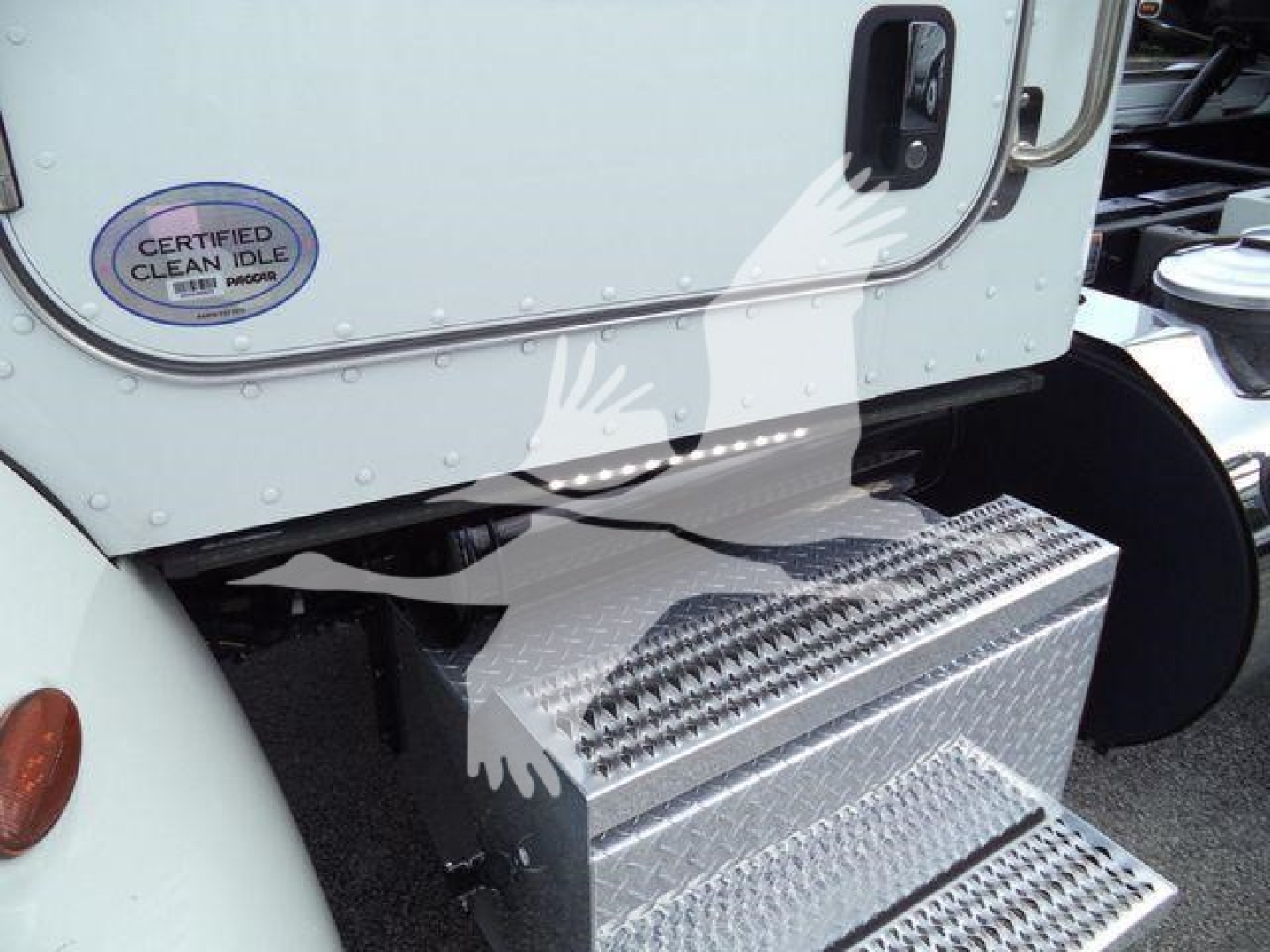 Truck side step box and entry door of a Peterbilt 337 rollback truck with diamond plate steps and 'Certified Clean Idle' sticker
