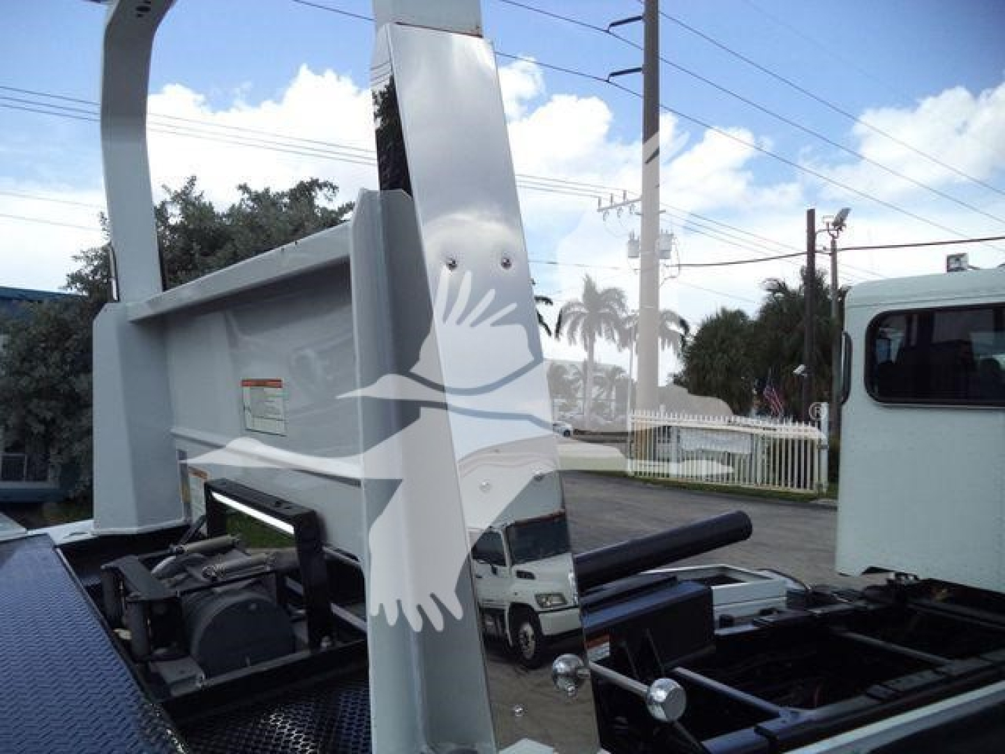 Peterbilt 337 rollback truck chassis with dump body and cab visible, stock number J61994FM; no other legible text.