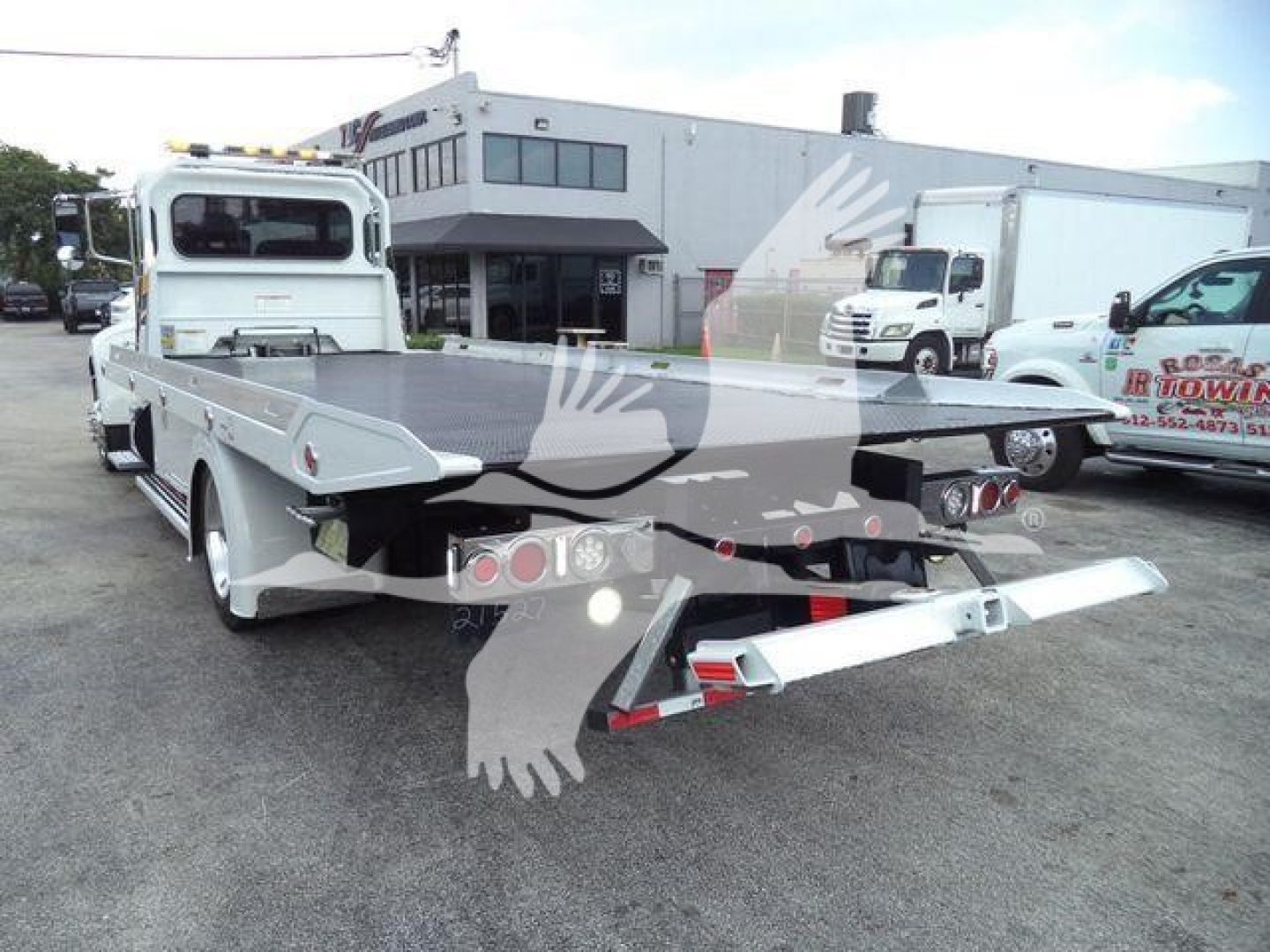 Peterbilt 337 rollback tow truck rear view showing flatbed and towing equipment.