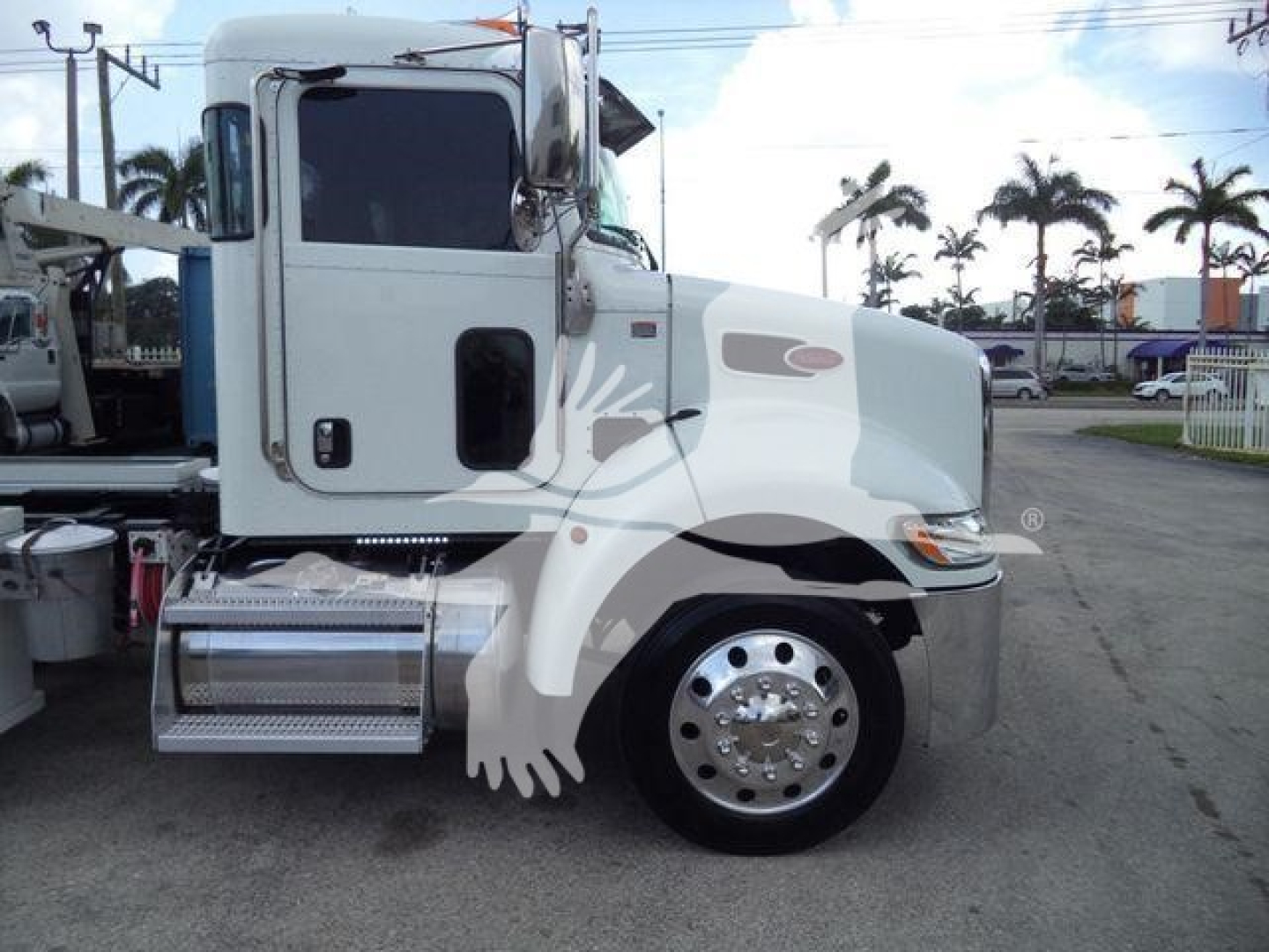 Peterbilt 337 rollback truck side view showing cab and front wheel, with chrome fuel tank and steps.