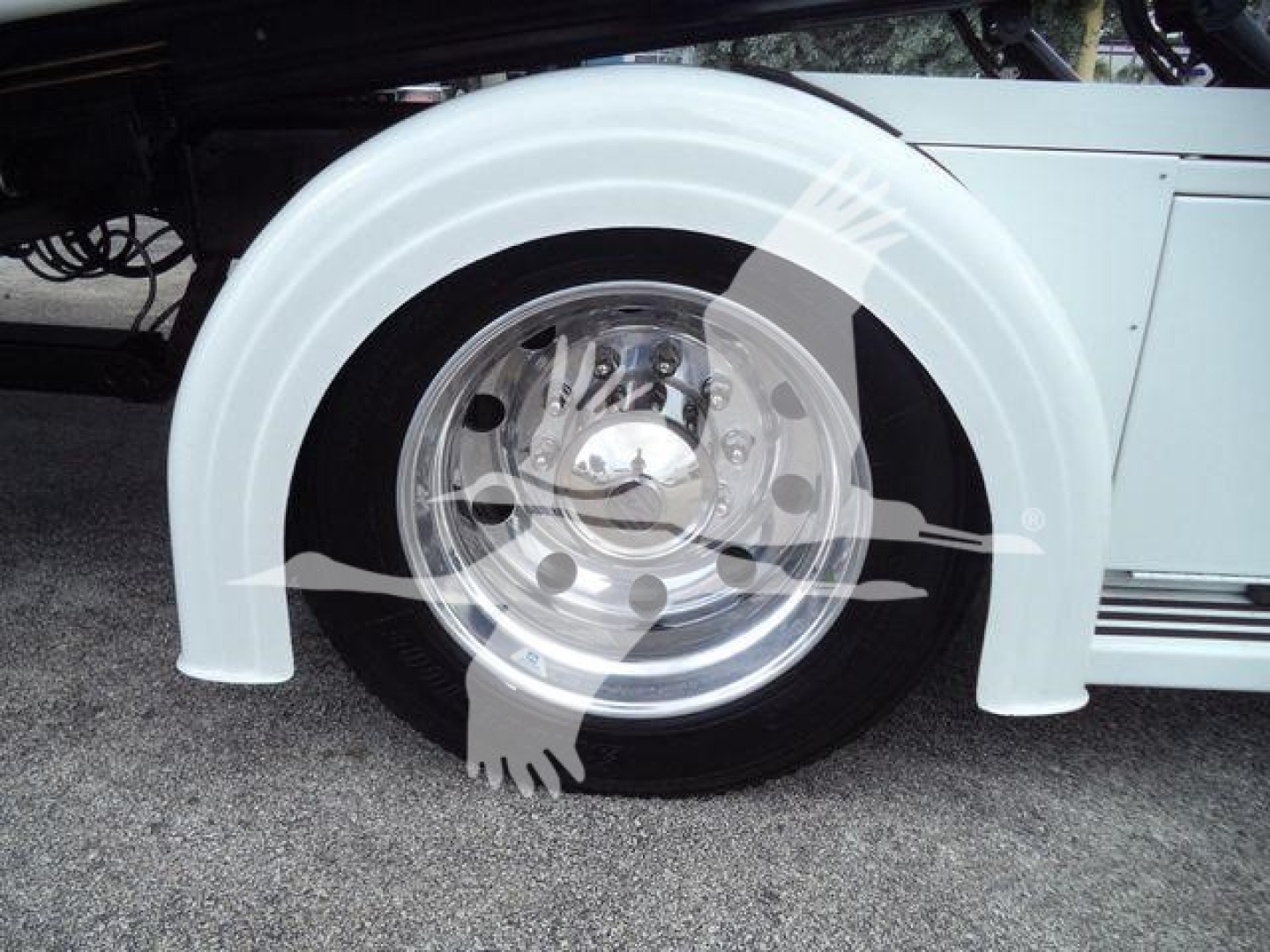 Peterbilt 337 rollback truck wheel and fender with chrome hubcap visible.