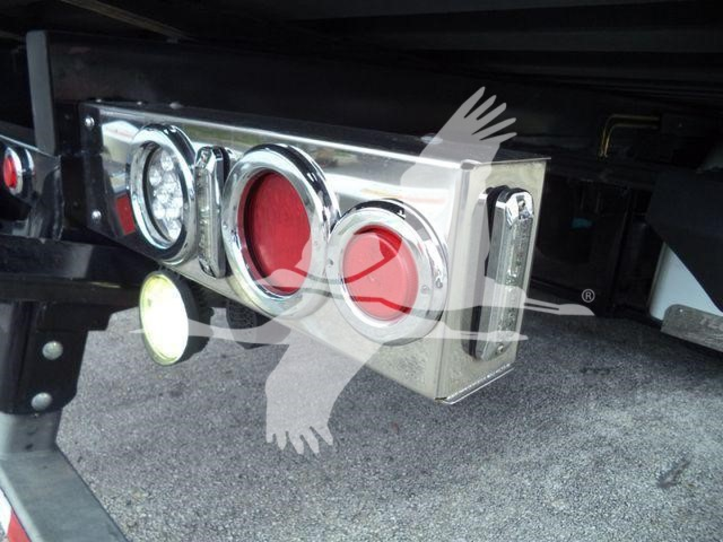 Peterbilt 337 undercarriage rear showing chrome luggage/tail light assembly and bumper area.