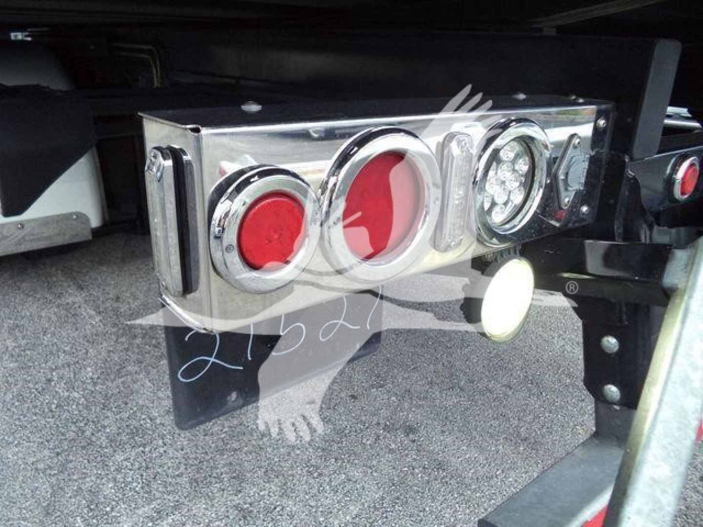 Peterbilt 337 rear/underneath showing chrome taillight bar with red and clear circular lenses and bumper hardware.