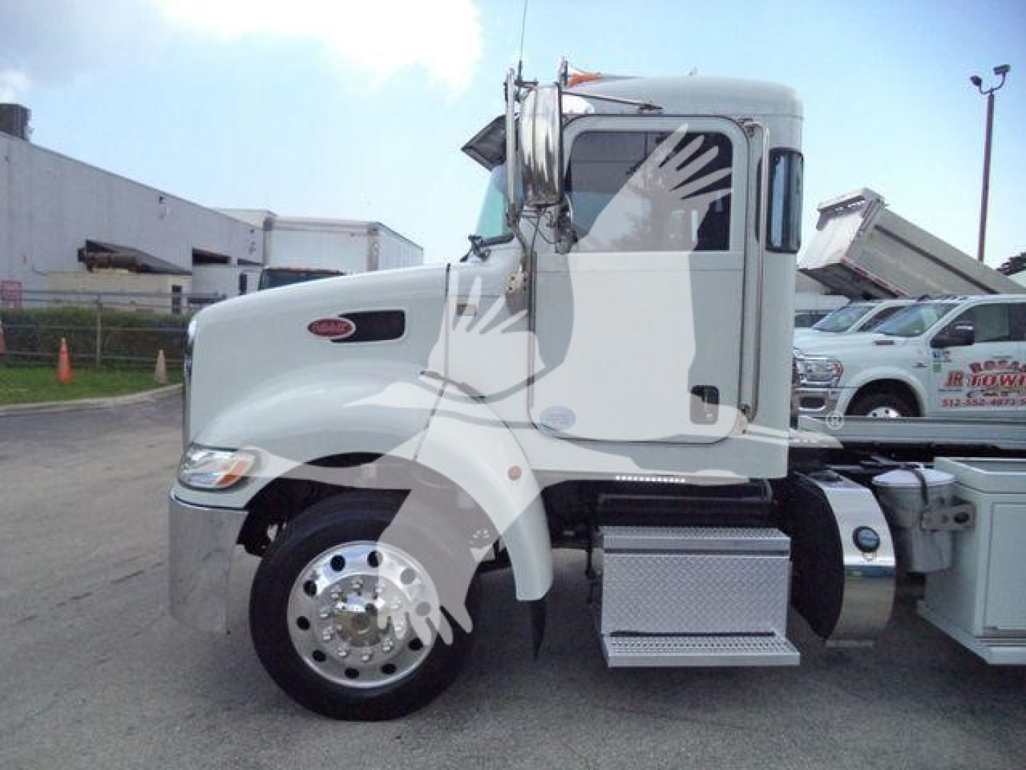 Peterbilt 337 truck side view showing cab, front wheel, and chrome steps.