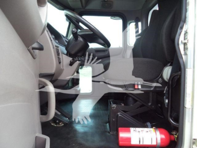 Interior of a 2022 Peterbilt 337 cab with steering wheel, driver seat, dashboard, and a mounted fire extinguisher visible.