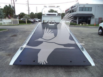 Peterbilt 337 rollback tow truck flatbed with graphic dove design viewed from rear deck.