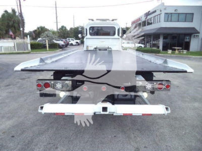 Peterbilt 337 rollback truck rear view showing flatbed with tail lights and bumper, stock number J61994FM, used 2022.