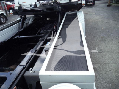 Peterbilt 337 rollback chassis showing hydraulic winch assembly and platform surface with textured grip panels.