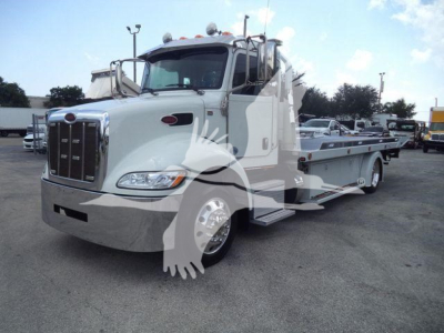 Peterbilt 337 rollback tow truck in white with long flatbed, front grille, headlights visible