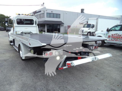 Peterbilt 337 rollback tow truck rear view showing flatbed and towing equipment.