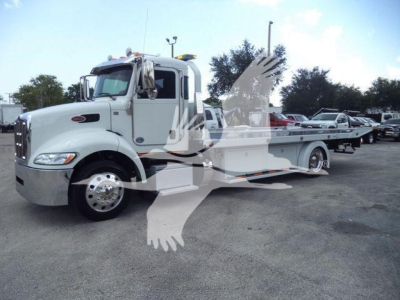 Peterbilt 337 rollback tow truck side view showing cab and flatbed with chrome wheels and light mounting.