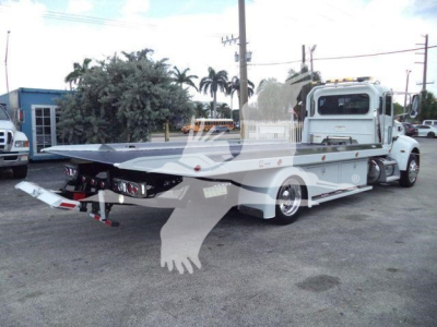 Peterbilt 337 rollback tow truck from rear-left angle with flatbed and chrome accents, light gray cab, and wheel wells visible.