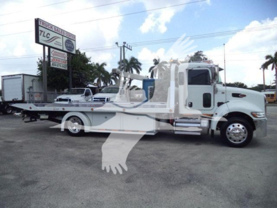Peterbilt 337 rollback truck in white profile view with flatbed and cab, stock number J61994FM visible nearby.
