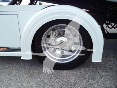 Peterbilt 337 rollback truck front wheel and white fender, chrome wheel hub, tire, and undercarriage components visible