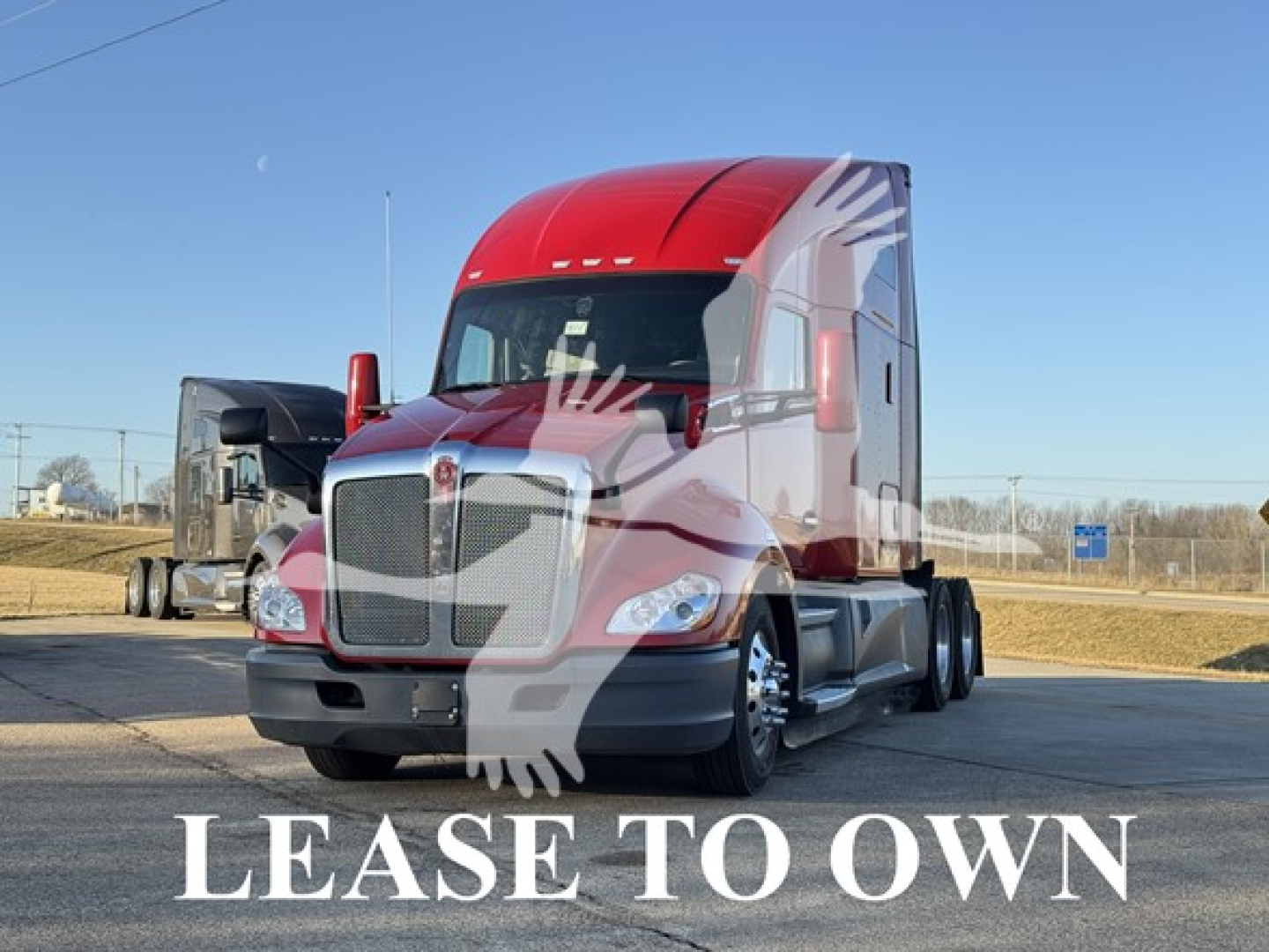 Kenworth T680 tractor in a lot labeled LEASE TO OWN with red cab and sleeper, front view.