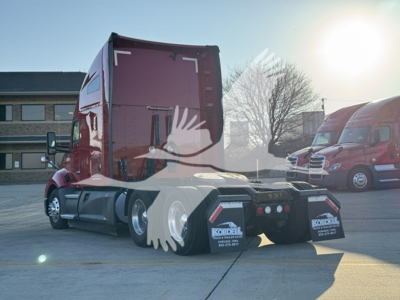 Kenworth T680 tractor rear view showing fifth wheel and rear lights with mud flaps.
