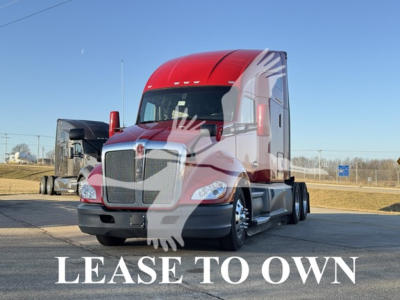 Kenworth T680 tractor in a lot labeled LEASE TO OWN with red cab and sleeper, front view.