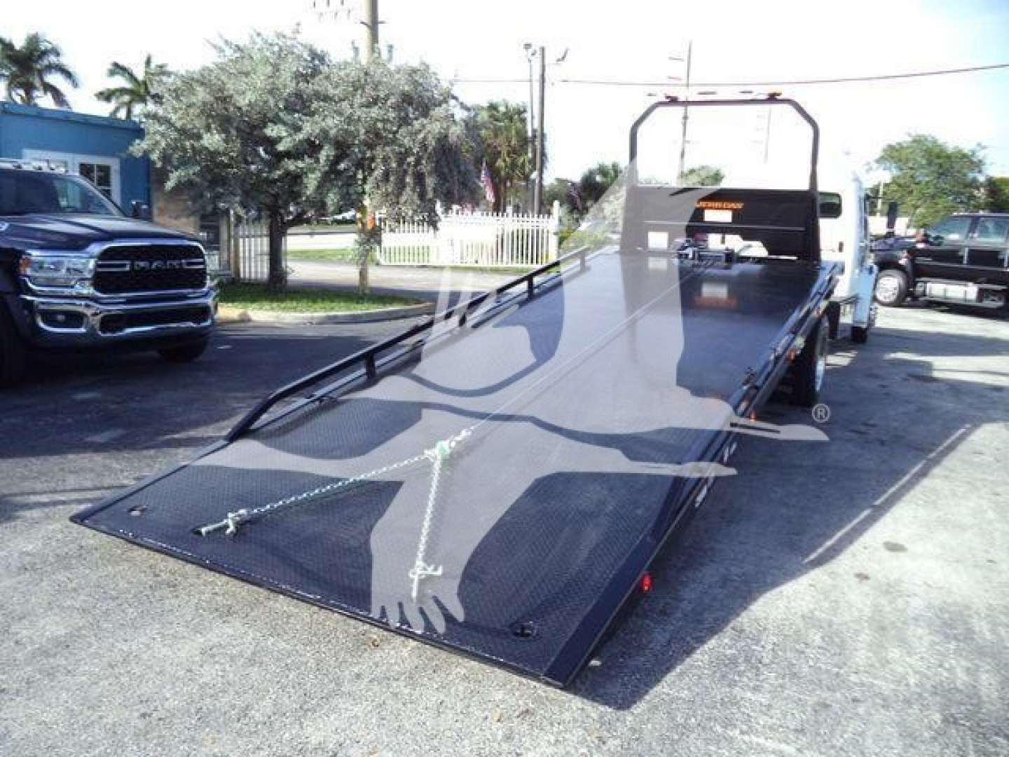 Tow truck flatbed with hydraulic ramp showing steel deck and rear hitch, Freightliner M2 106 Plus stock image