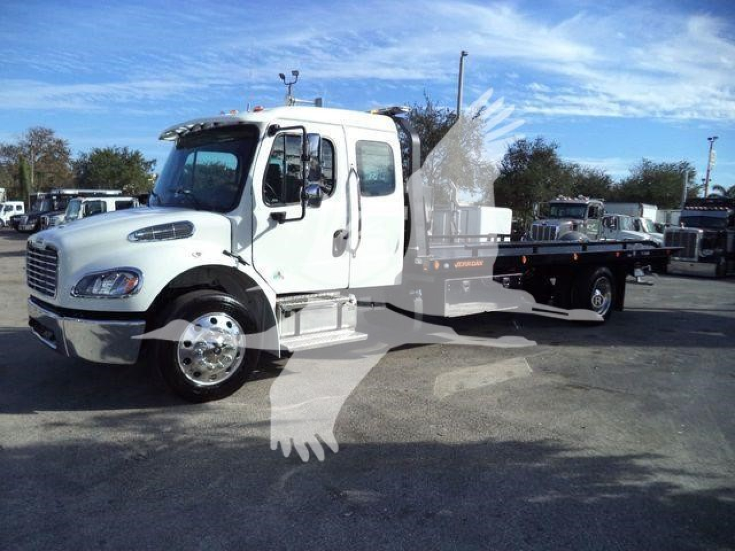Freightliner M2 106 Plus rollback truck in serviceable condition with flatbed/rollback bed and chrome wheels.